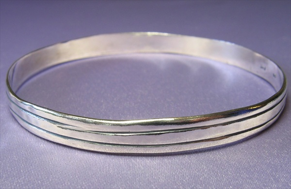Visit BIB2566 Hammered and oxidised sterling silver bangle with parallel stripes